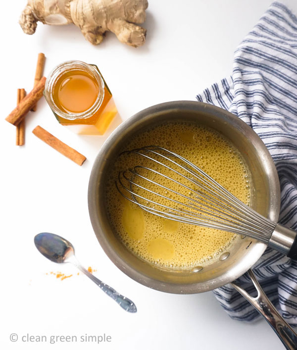 Whisking turmeric into cashew milk