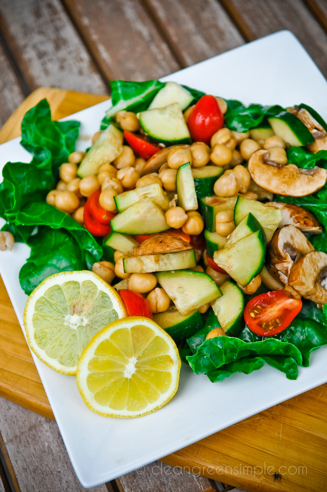 Chickpea and cucumber salad on a bed of greens.