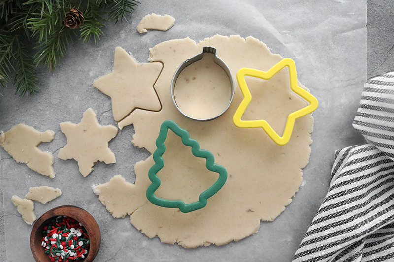 cutting out sugar cookies with cookie cutters