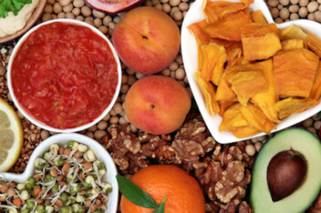 Healthy plant based diet foods with grains, nuts, dips, bean curd, fruit, vegetables, legumes and spices.