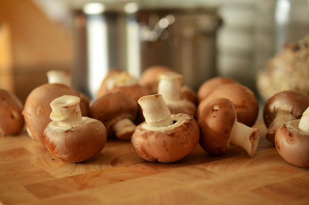 Cremini mushrooms on a cutting board