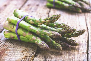 Fresh, raw asparagus on a rustic wooden table