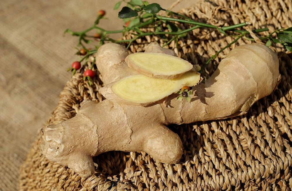whole ginger root with slices on a basket