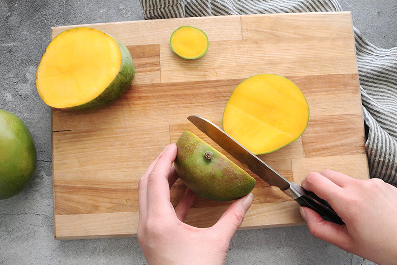 a sliced mango on a cutting board