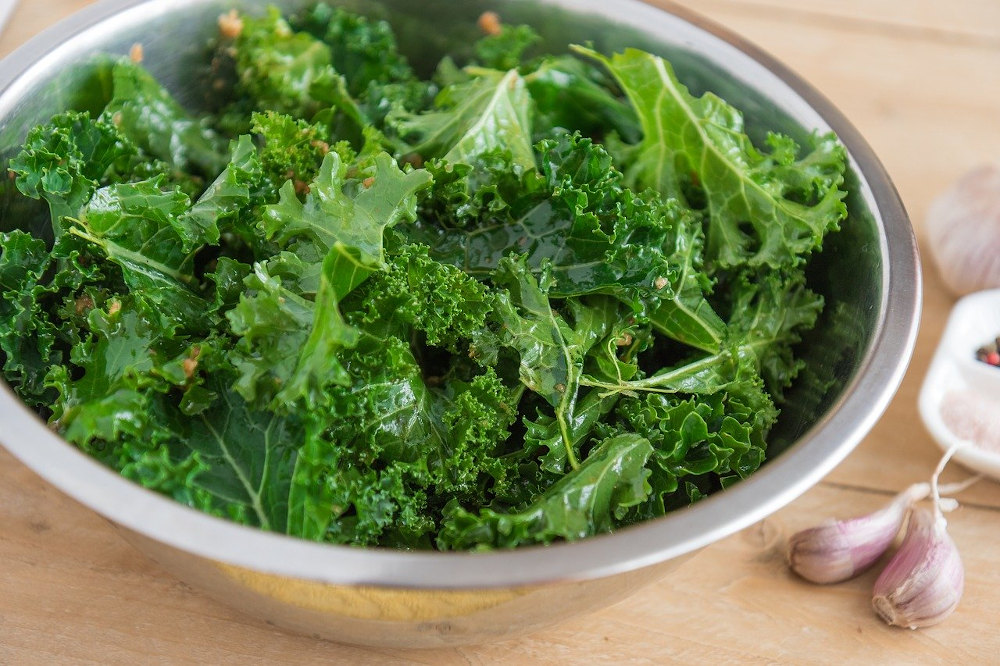 Kale in stainless steel bowl with garlic