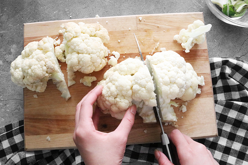 Cutting cauliflower on a cutting board 