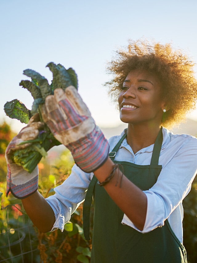 Young African American woman holding kale