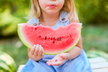 Young girl eating a watermelon