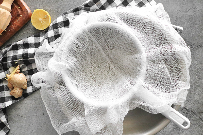 cheesecloth over a strainer in a bowl