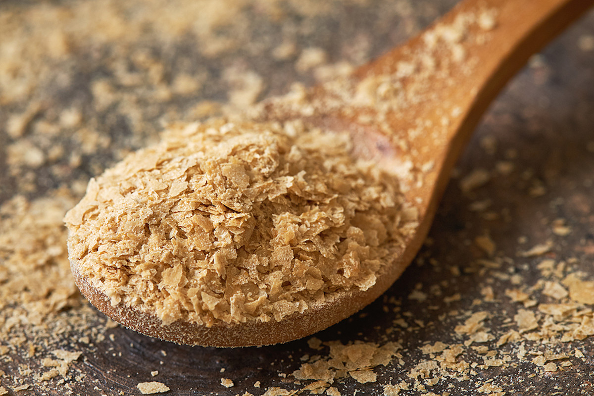 Nutritional yeast in a wooden spoon