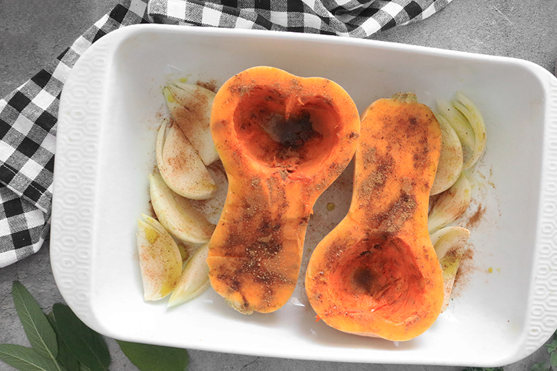 Butternut Squash seasoned and sitting in a casserole dish