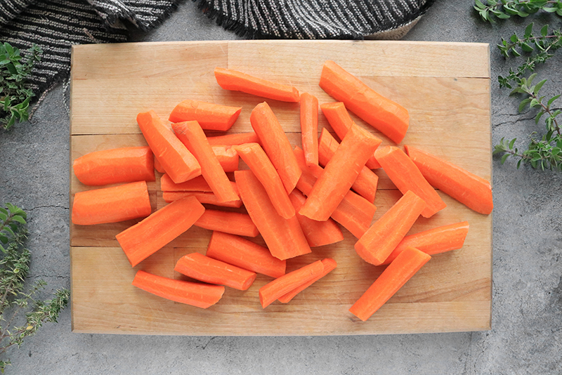 Peeled and cut carrots on a cutting board
