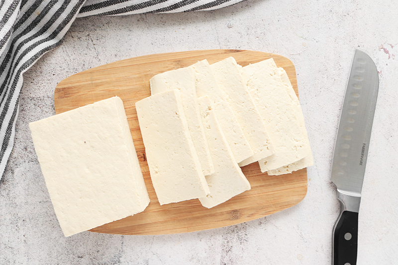 pressed tofu on a cutting board