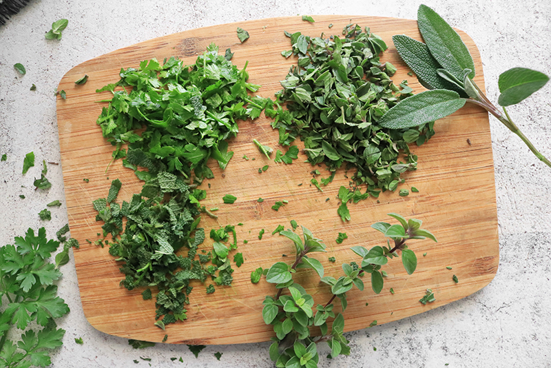 chopped herbs on a cutting board