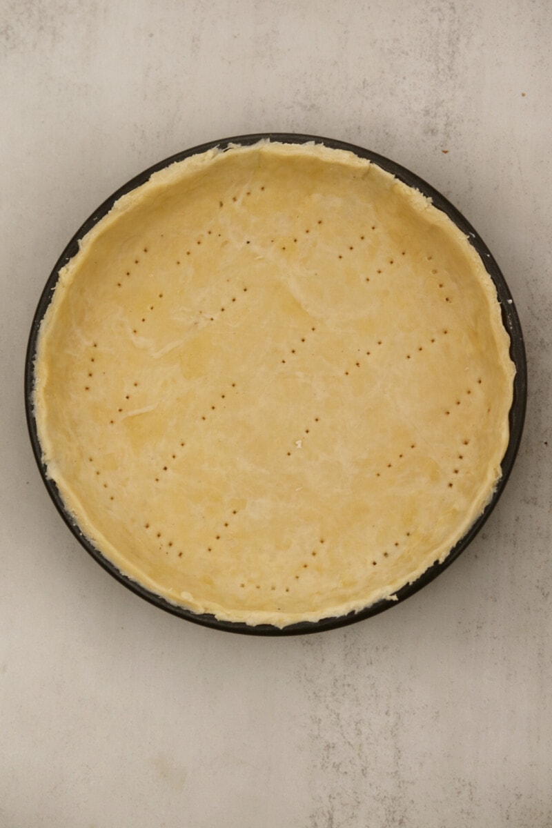 Vegan pie crust pierces with a fork and pre-baked.