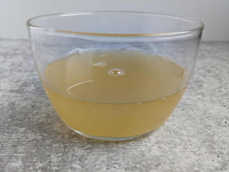 Aquafaba in a clear glass bowl.