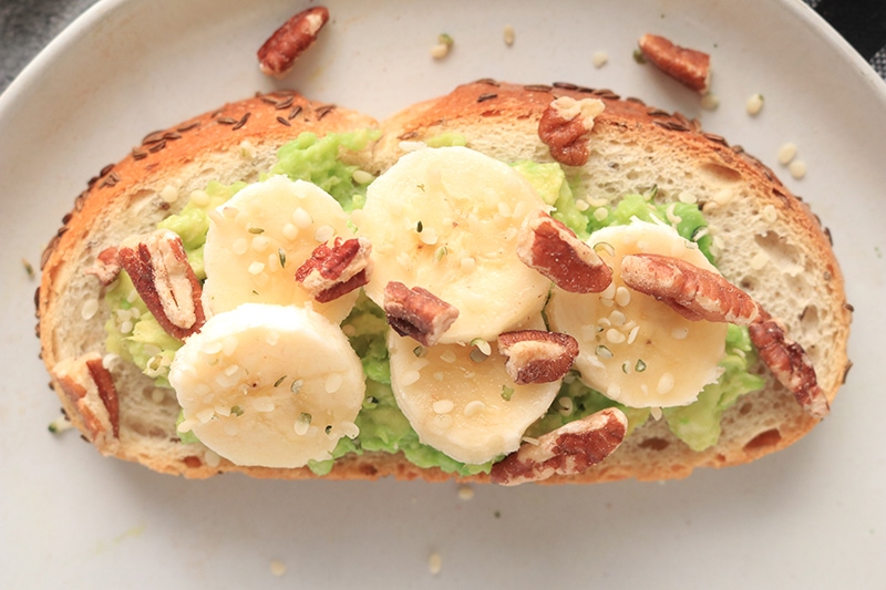 Avocado Toast with bananas, walnuts, and sesame seeds