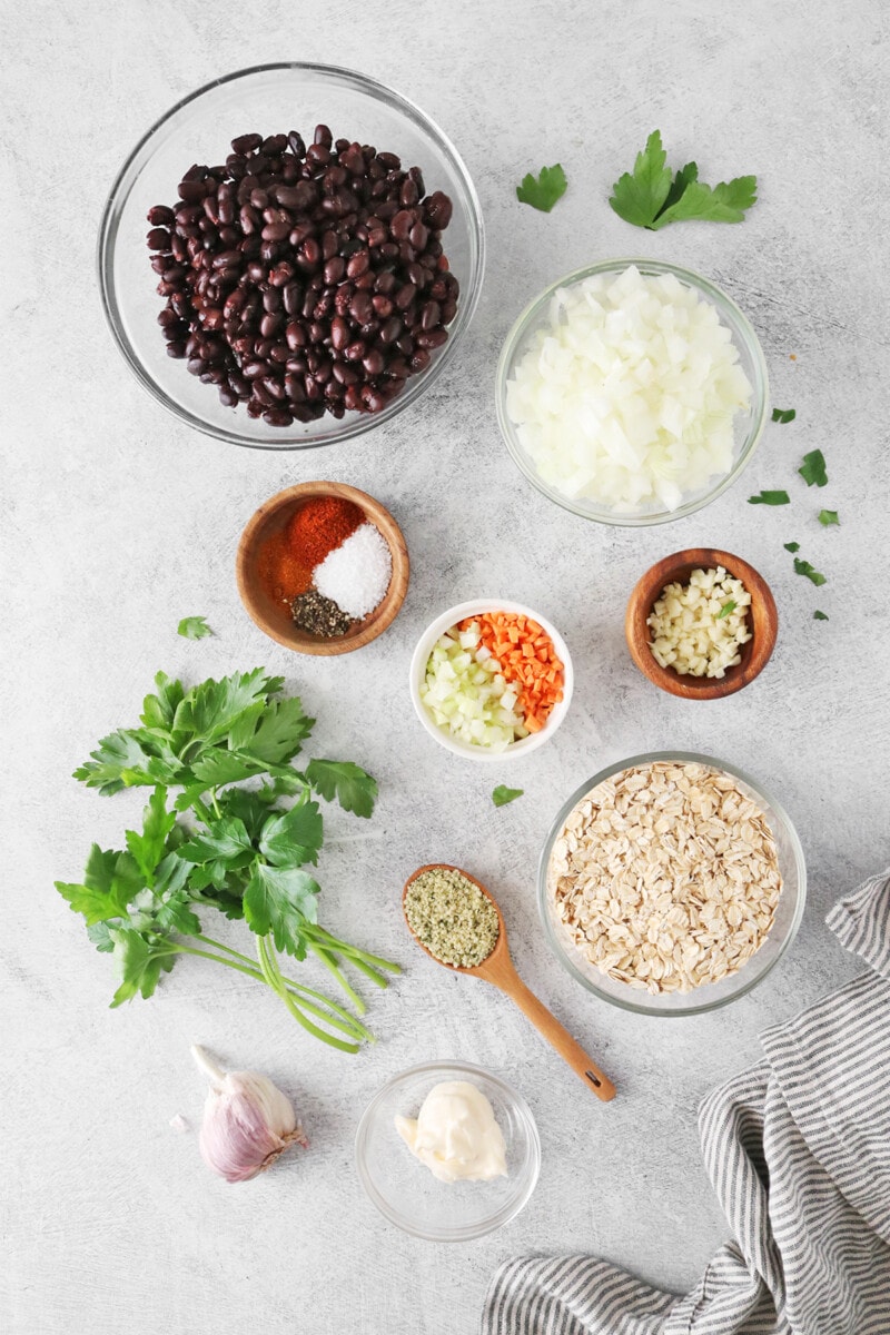 Ingredients for black bean burgers with oats: Black beans, onion, carrot, celery, garlic, spices, and oats.