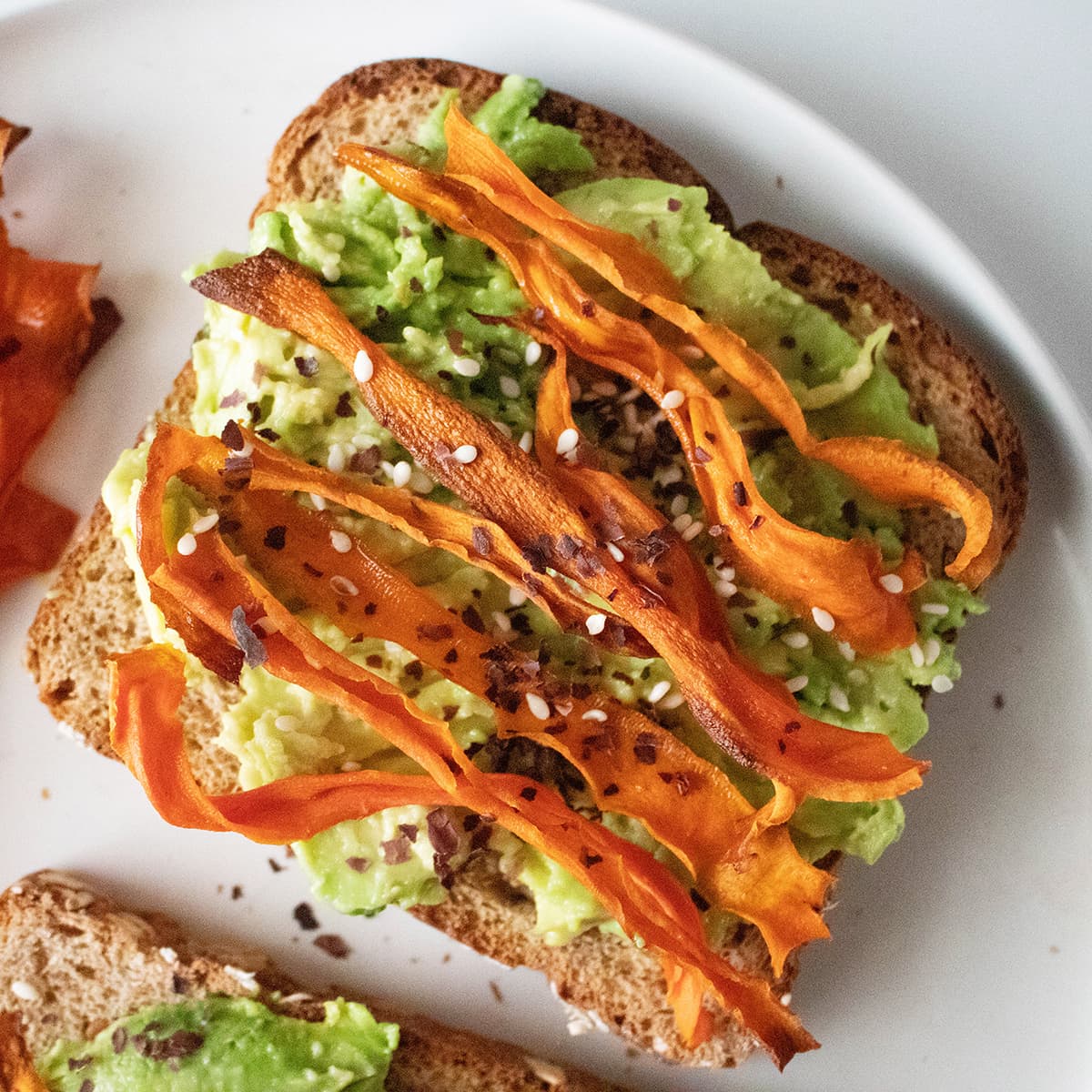 Carrot bacon on avocado toast