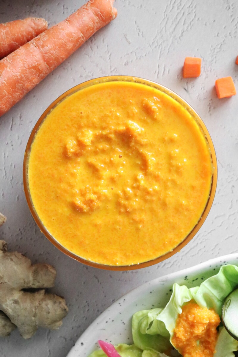 Carrot ginger dressing in a small glass bowl.