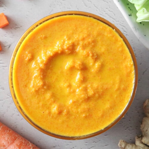 Carrot ginger dressing in a small glass bowl.