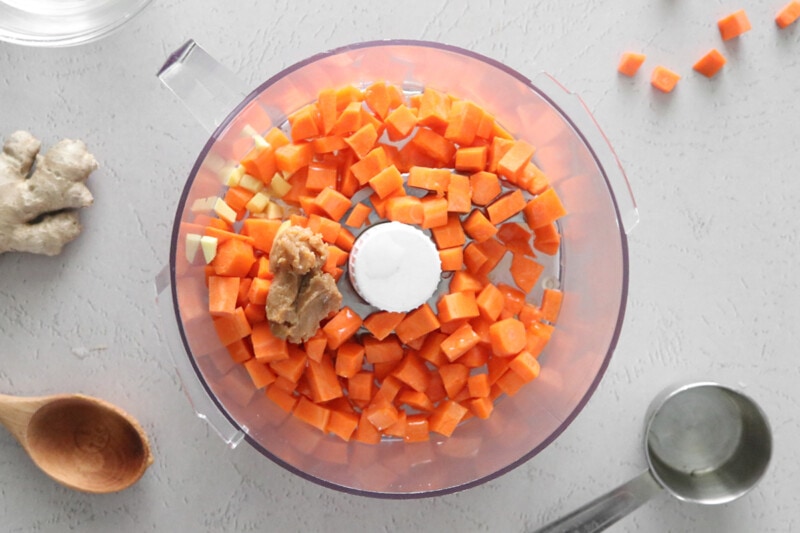 Carrot ginger dressing ingredients in a food processor.