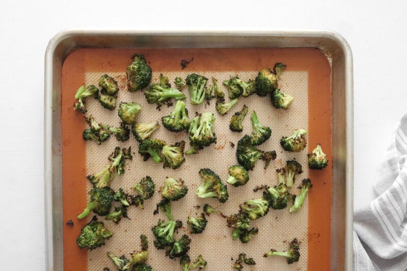 Roast broccoli florets on a silicone baking sheet