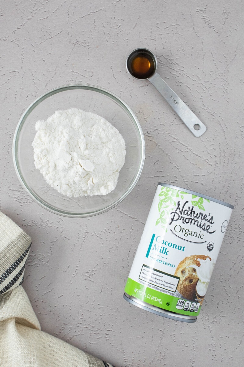 Ingredients for coconut milk whipped cream: vegan powdered sugar, vanilla extract, and a can of Nature's Promise organic coconut milk.