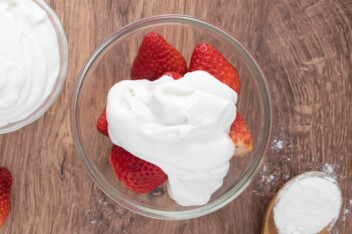 Coconut milk whipped cream on fresh strawberries