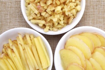 Fresh ginger prepared in various ways: chopped, sliced, and minced.