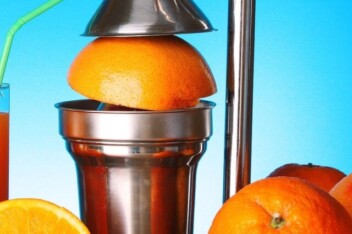 cropped-manual-lever-juicer-and-oranges-on-blue-background.jpg