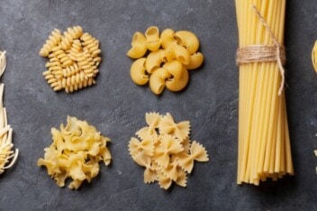 Different types of pasta on a black background.