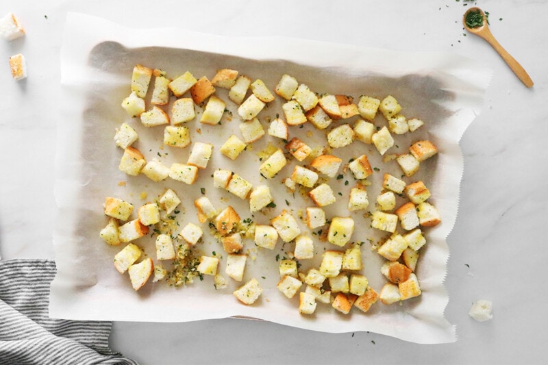 Croutons before baking on a baking sheet.
