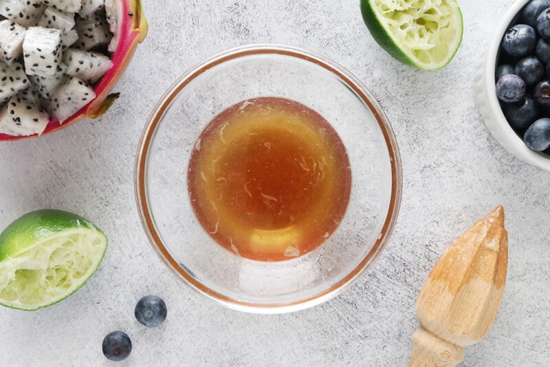 Maple syrup and lime juice in a bowl.