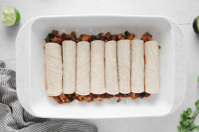 Roll tortillas and place in dish