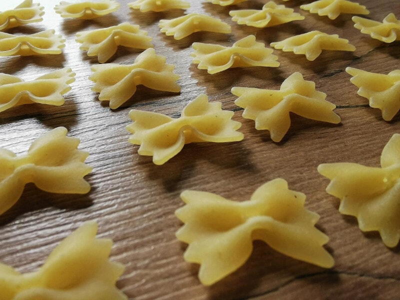 Dry Farfalle Pasta on a wooden table.