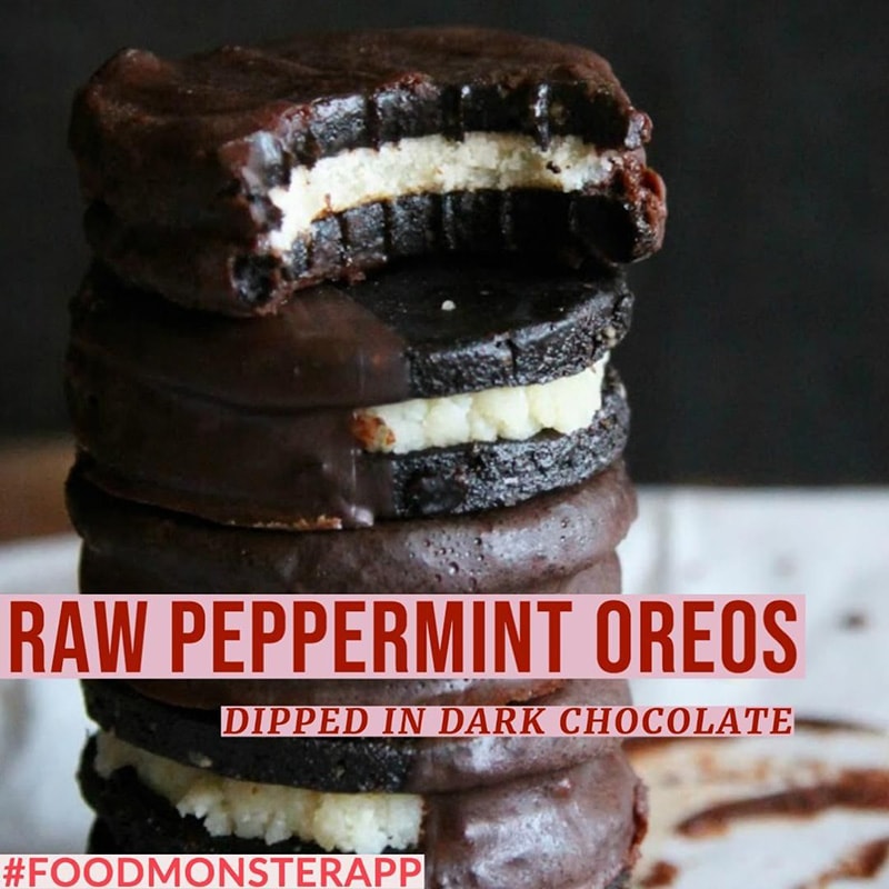 A stack of raw, vegan peppermint oreos dipped in chocolate.