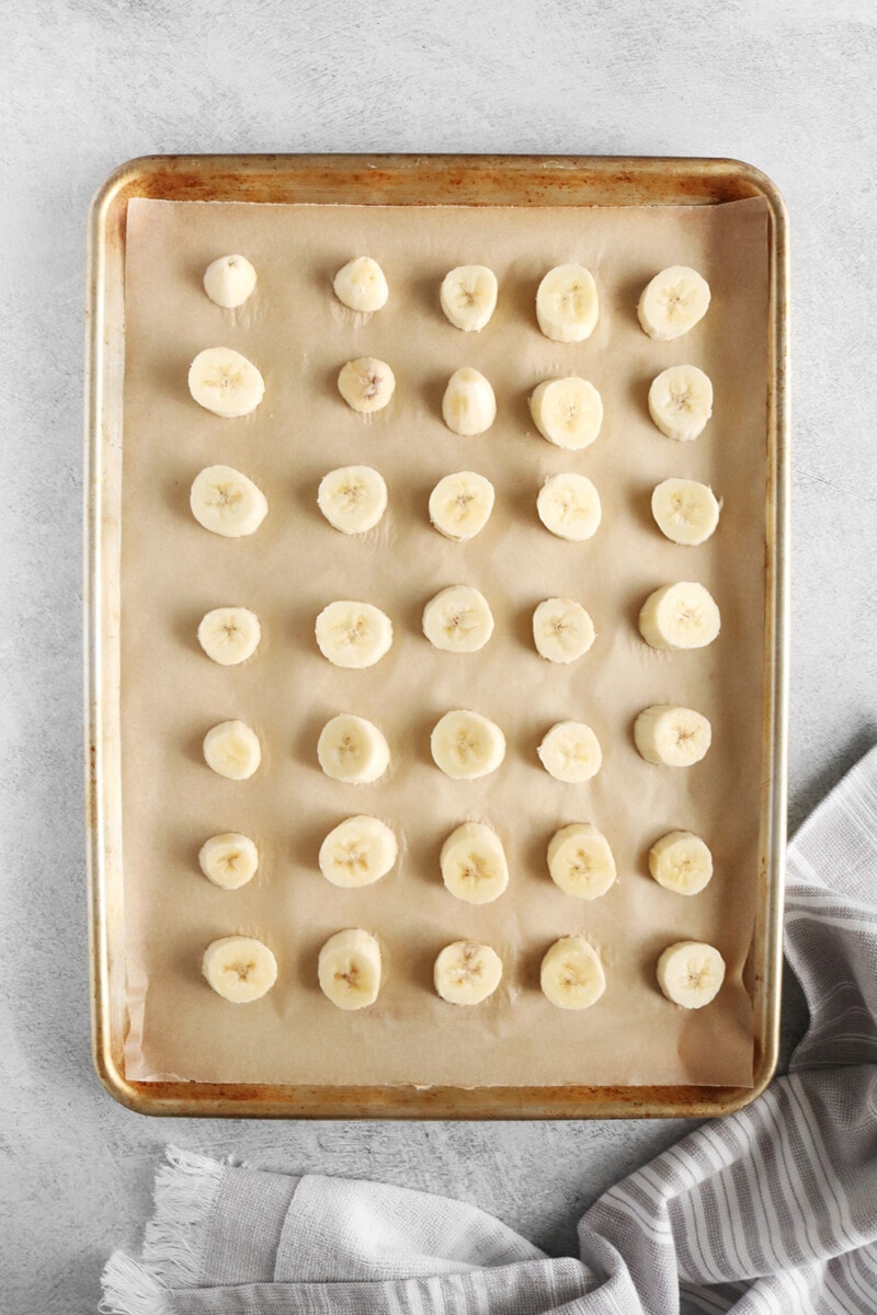 Banana slices on a baking sheet with parchment paper