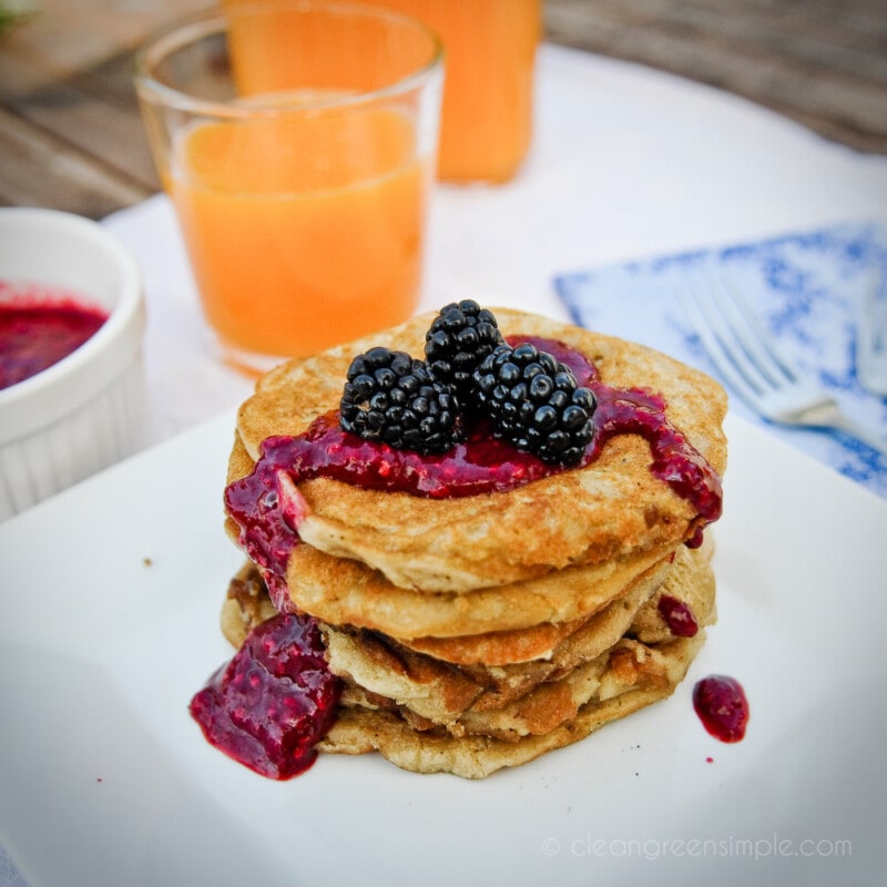 Gluten-free vegan pancakes with blackberries on a while plate.
