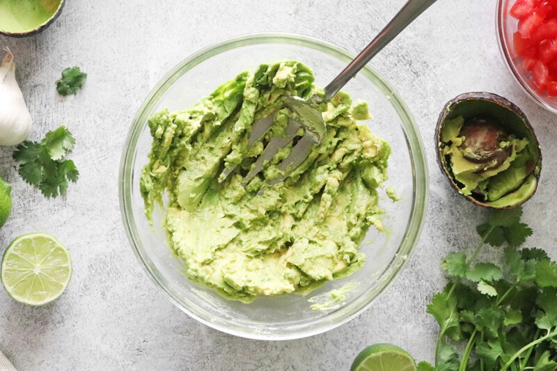 Mashed avocados in a bowl.