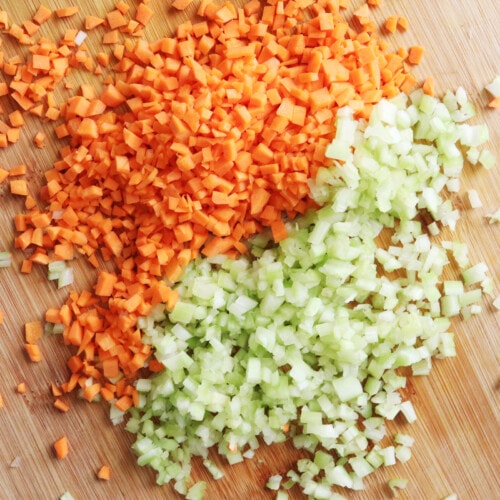 Minced celery and carrots on a cutting board