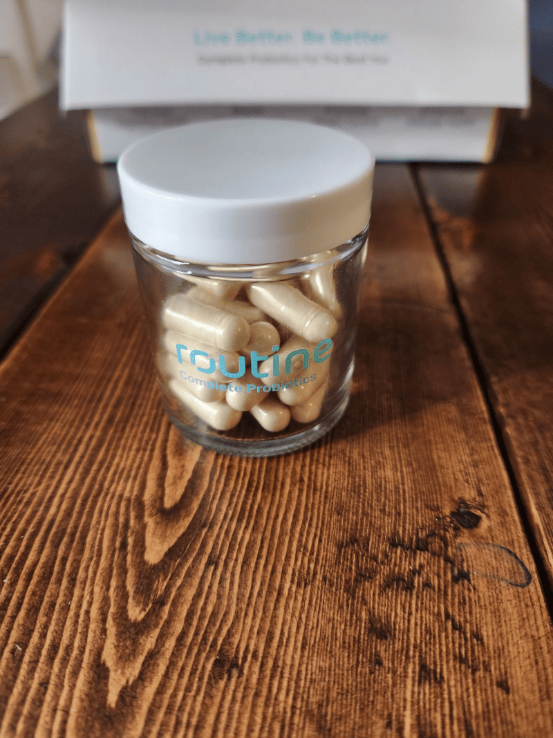 Routine glass jar filled with probiotic supplements.