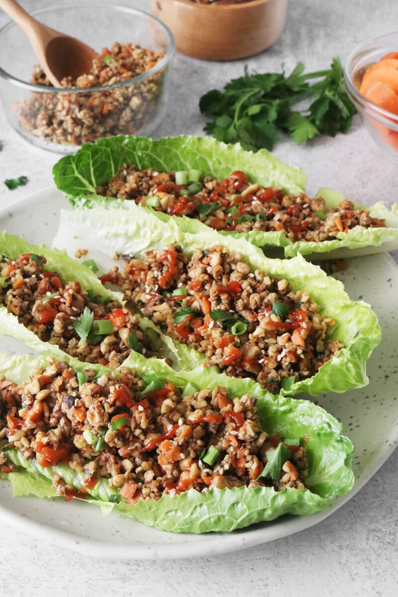 Vegan lettuce wraps on a white plate.