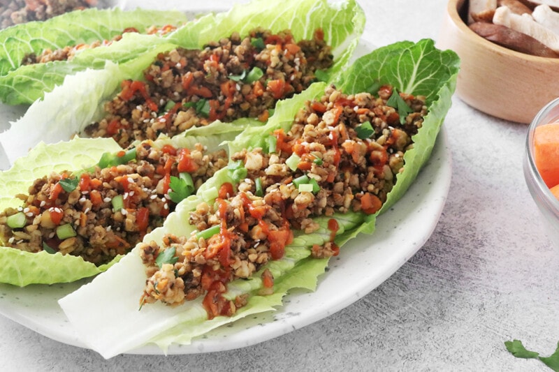 Vegan lettuce wraps on a white plate.