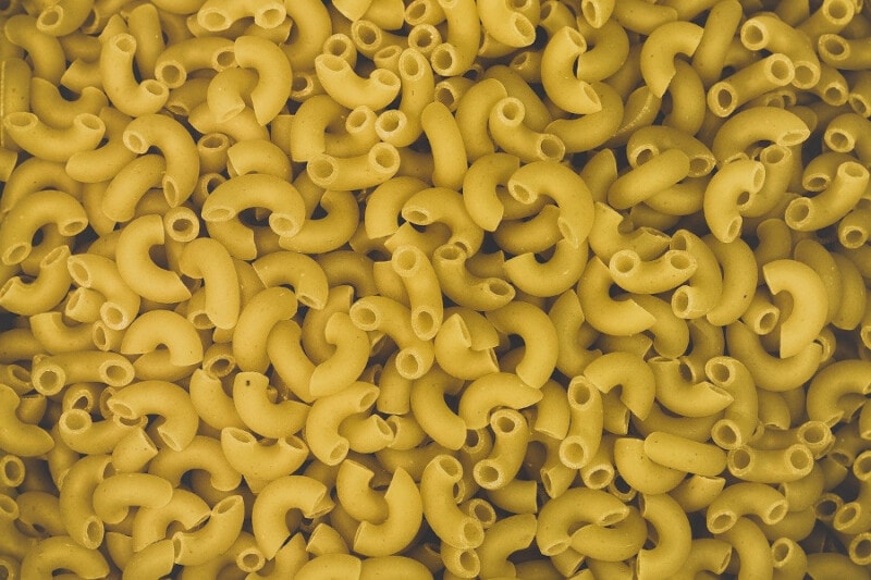 Uncooked Macaroni pasta close-up view.