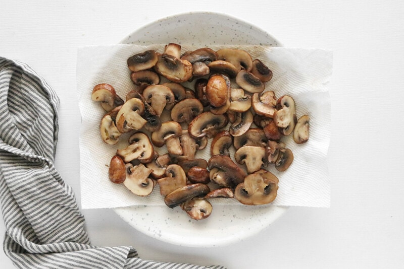 sauteed mushrooms drying on a paper towel