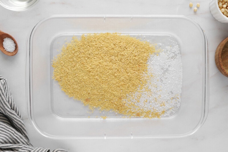 Nutritional yeast and salt mixed together in a large baking dish.