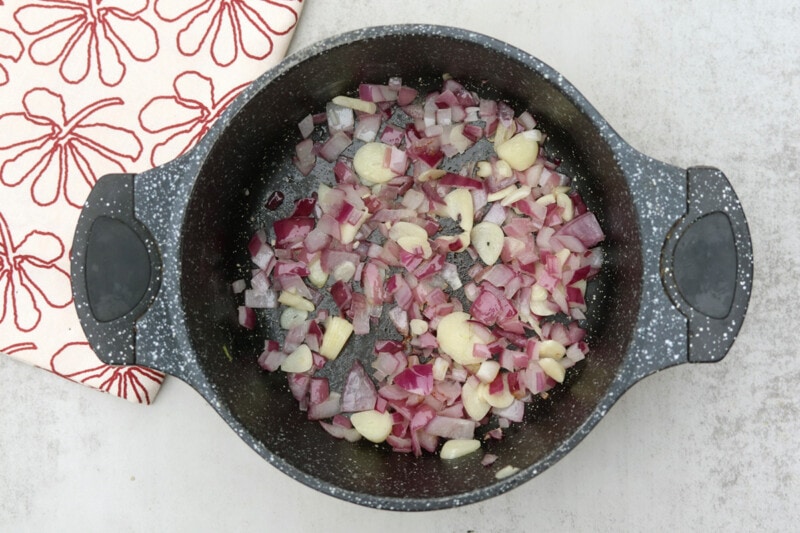Saute onions and garlic in a large pot until softened.