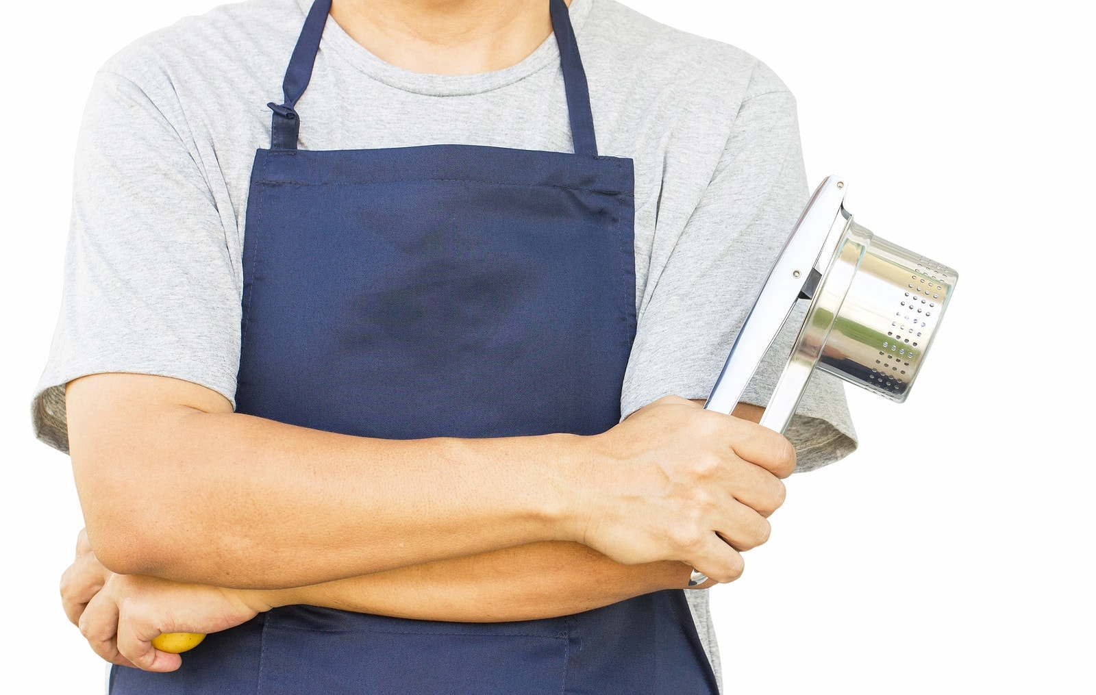Male chef in blue apron holding a potato ricer