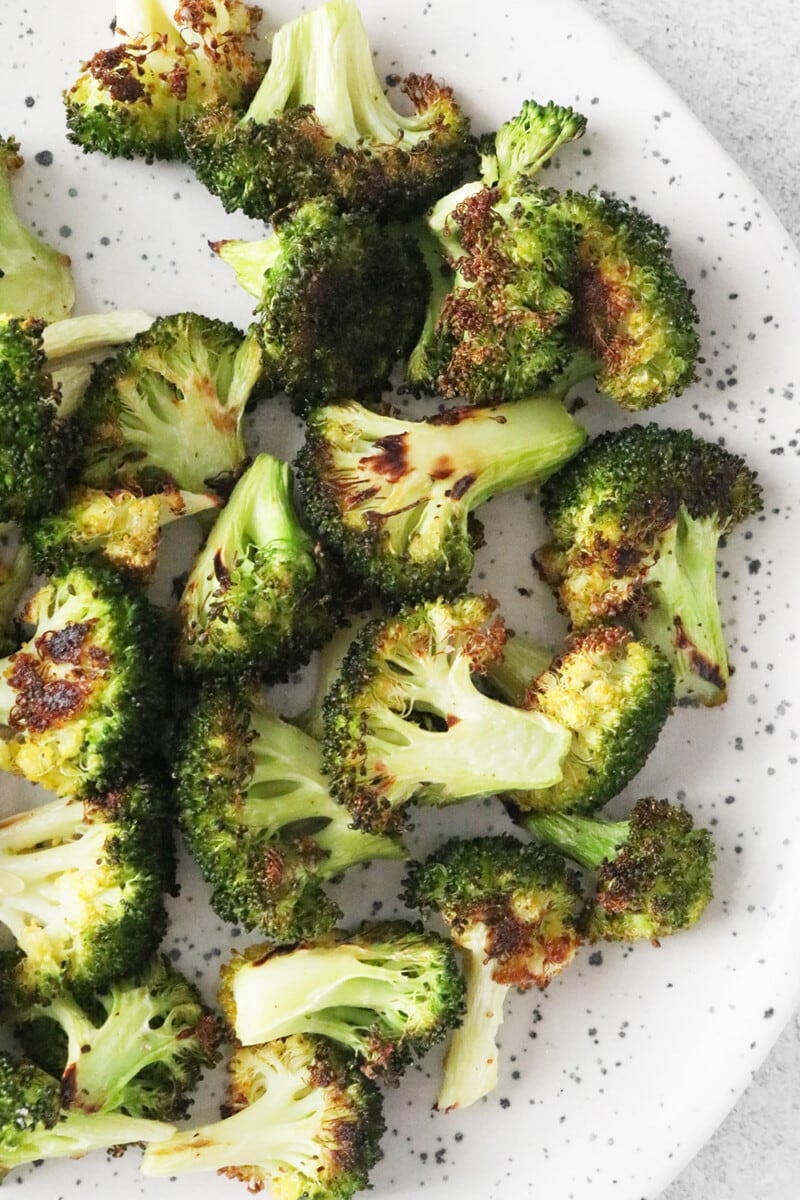 Roasted broccoli on a white plate